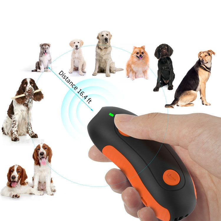 Ultrasonic dog repeller held in hand with orange control buttons and green power light