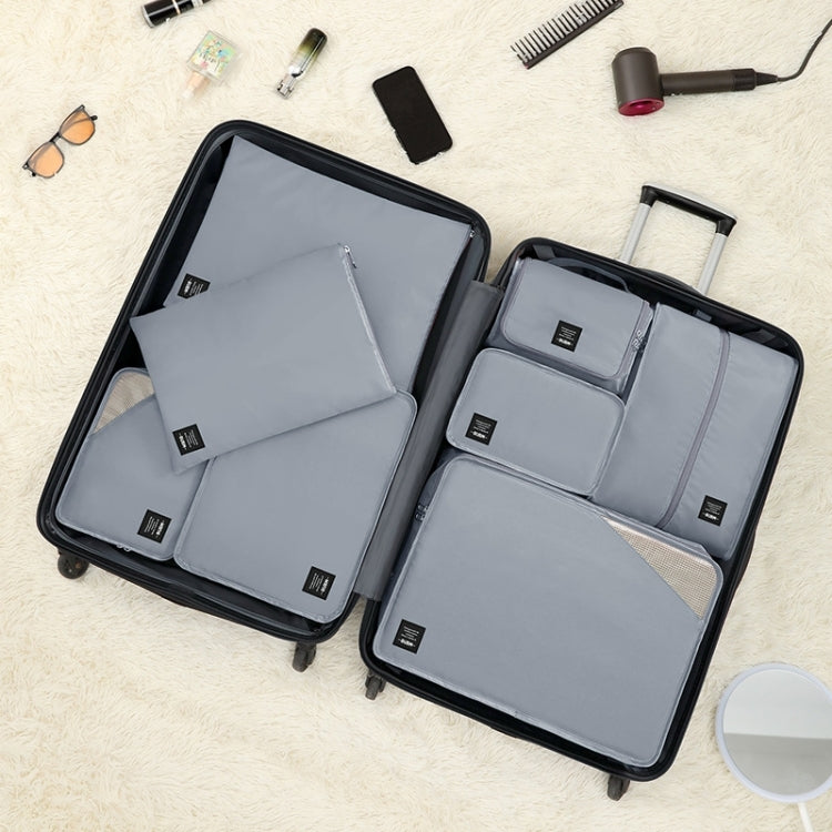 Light blue packing cubes and pouches inside an open travel suitcase