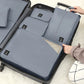 Light blue packing organizer with zippered compartments inside suitcase
