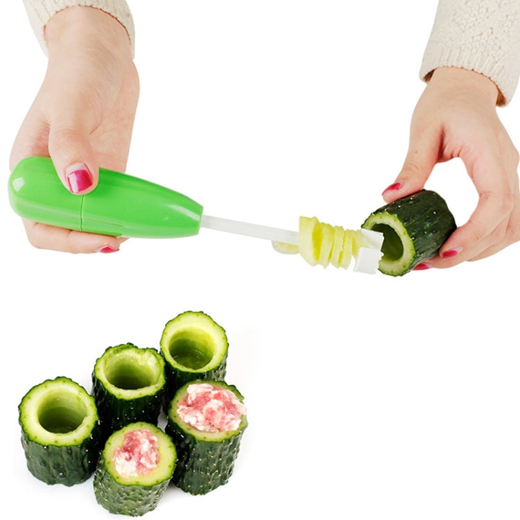 Green vegetable core digger with hollowing blade, used to scoop cucumber cores