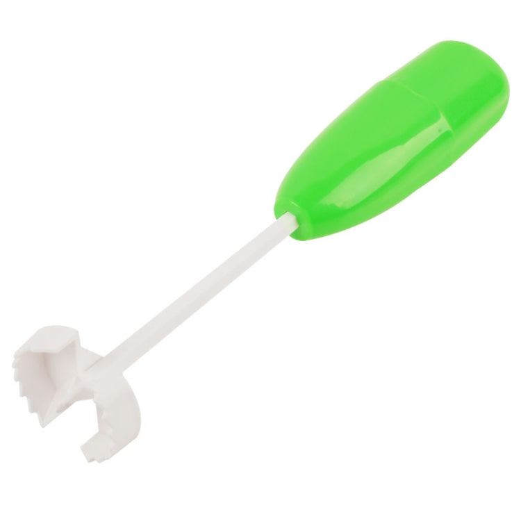 Green vegetable core digger with long white prong and serrated tip for coring