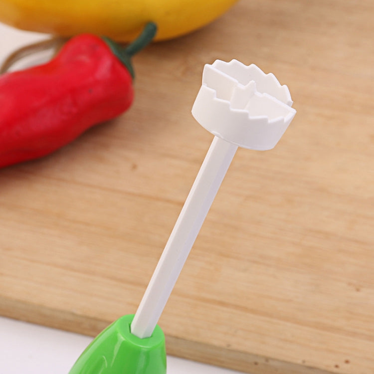Vegetable core digger tip shown on white prong with green handle