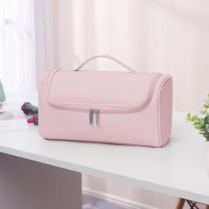 Pink storage bag with top handle and front flap zip closure