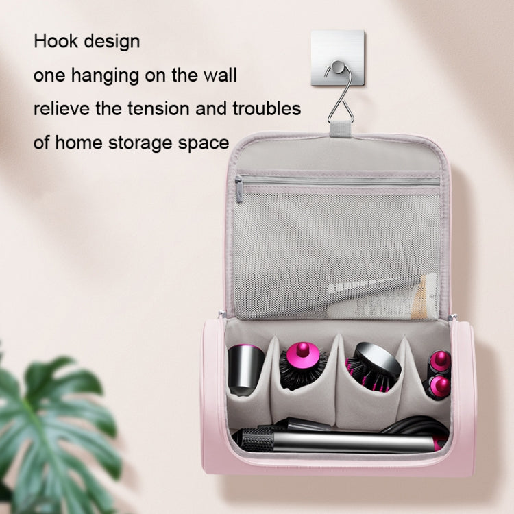 Pink hanging organizer bag with mesh pocket and multiple accessory compartments