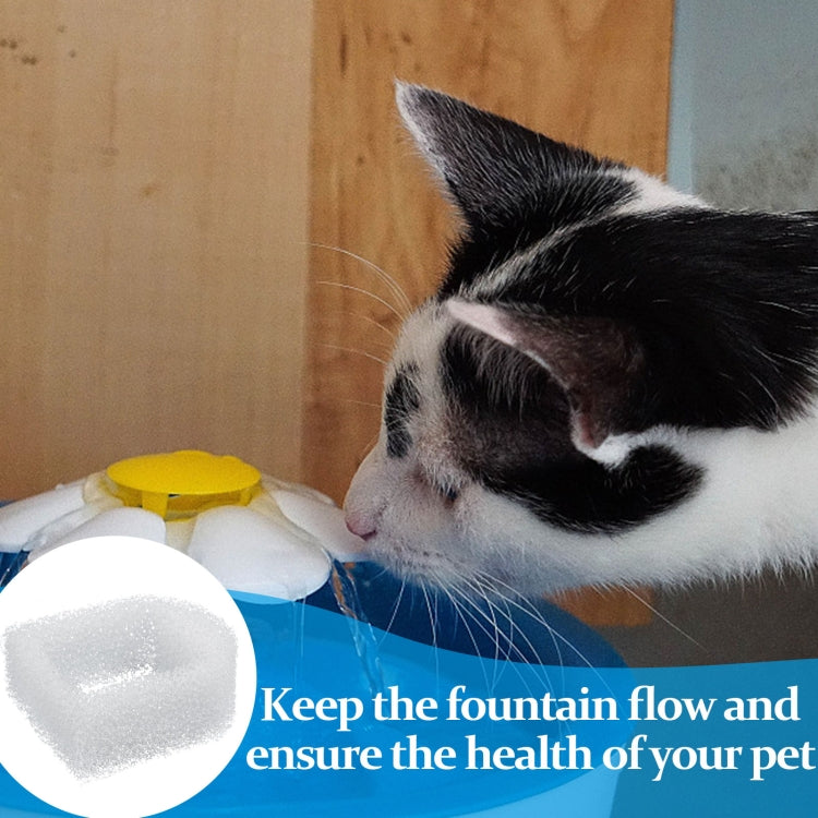 White pet water fountain filter cotton pad beside a cat drinking
