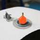 Inflatable paddle board air valve adapter with orange top and brass nozzle on gray base