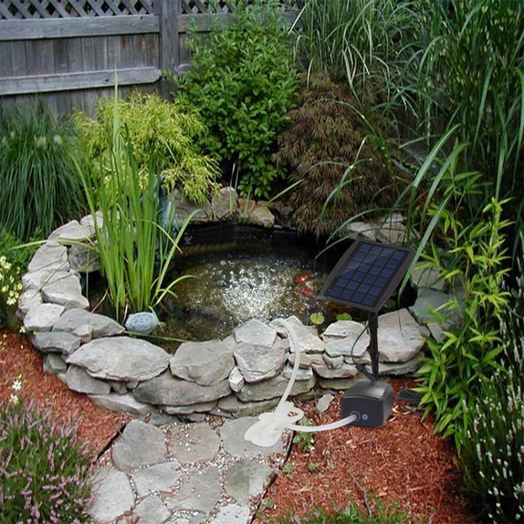 Solar-powered pond aeration pump with solar panel, air outlet, and bubbling water