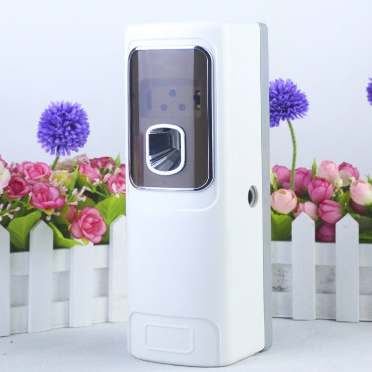 White automatic fragrance sprayer with front sensor window and spray nozzle opening