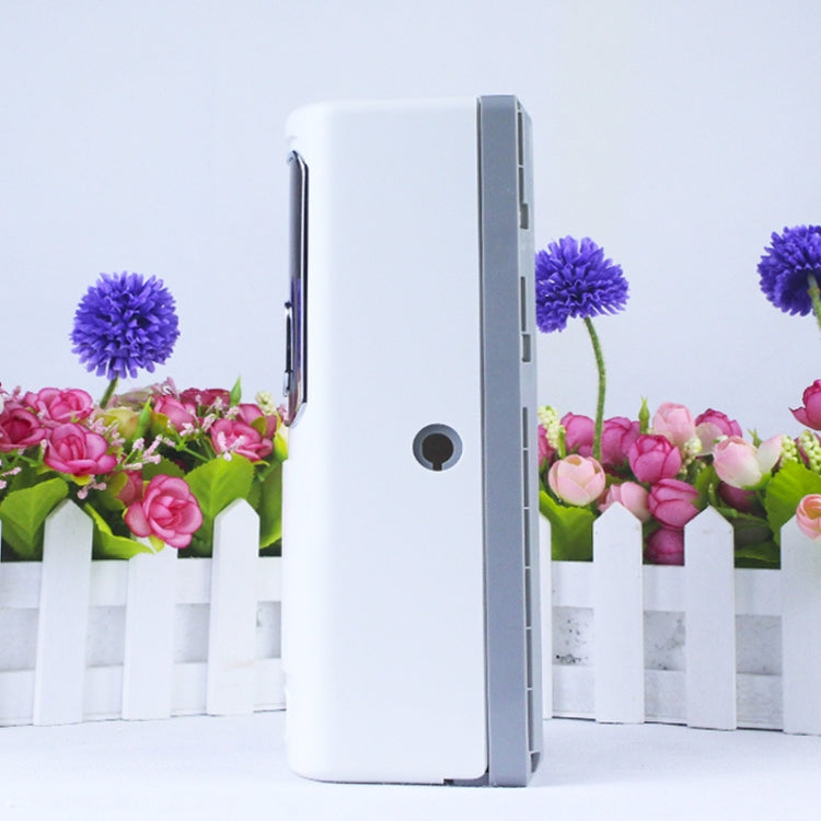 White automatic fragrance sprayer side view with circular access port on casing