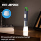 LED flashlight with white lampshade extended, green handle loop, casting light beam