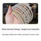 Pearl beaded headband with layered curved straps and gold-toned accent lines