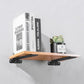 Black triangular shelf partition bracket with mounting holes, holding a floating wooden shelf