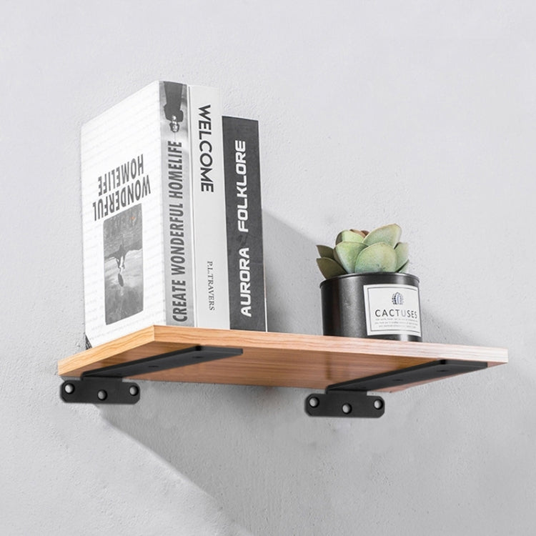 Black triangular shelf partition bracket with mounting holes, holding a floating wooden shelf