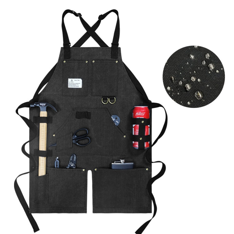 Black canvas work apron with crossed back straps and front tool pockets
