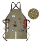 Olive green canvas work apron with crossed back straps and front tool pockets