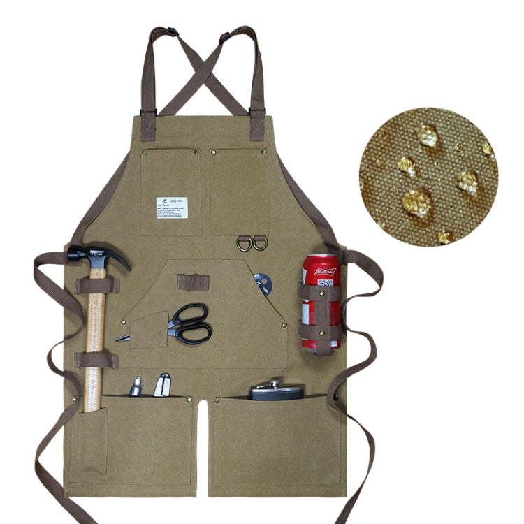 Olive green canvas work apron with crossed back straps and front tool pockets