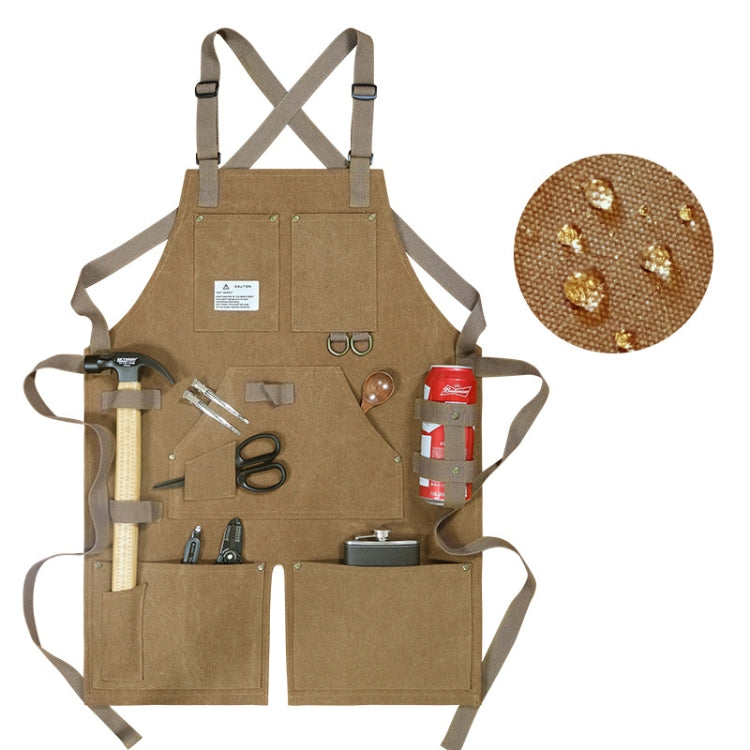 Tan/brown canvas work apron with crossed back straps and front tool pockets