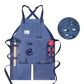 Blue canvas work apron with crossed back straps and multiple front tool pockets