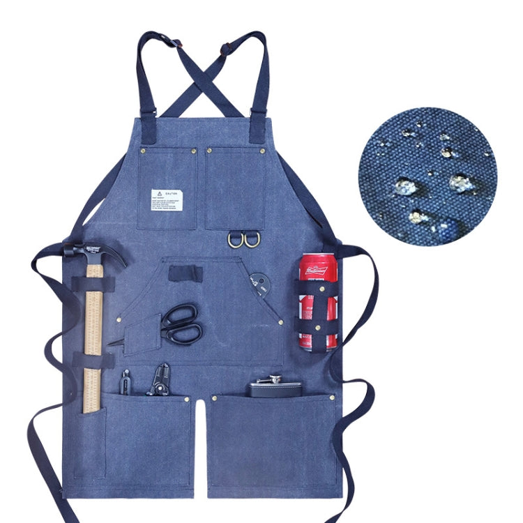 Blue canvas work apron with crossed back straps and multiple front tool pockets