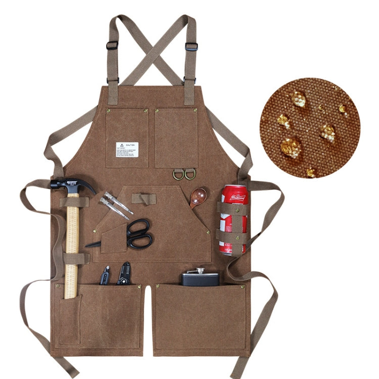 Brown canvas work apron with crossed back straps and front tool pockets