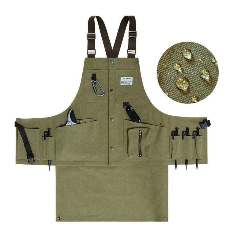 Olive canvas tool apron with multiple pockets, metal D-ring, and adjustable suspenders