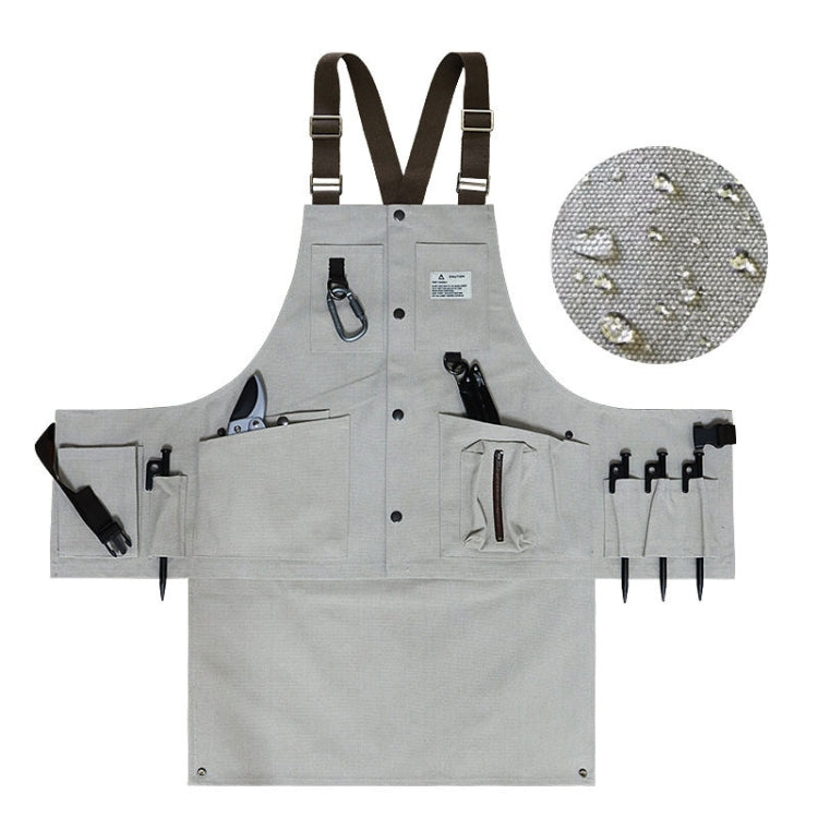 Light gray canvas tool apron with multi pockets, tool slots, and adjustable straps