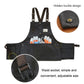 Dark canvas tool apron with adjustable suspenders, front pockets, and hanging tool loop