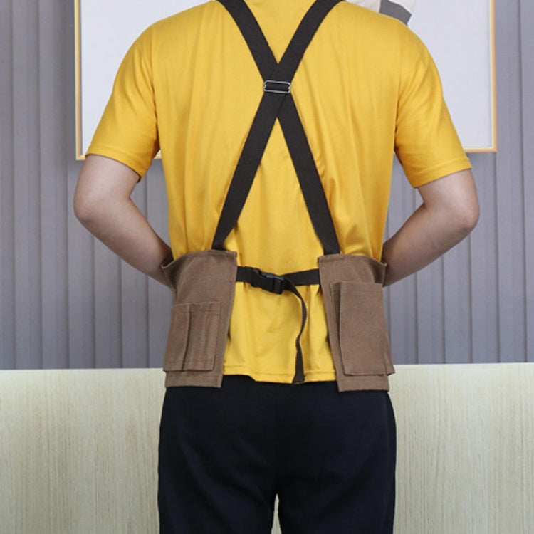 Brown canvas tool apron with back crisscross straps and two front leg pockets