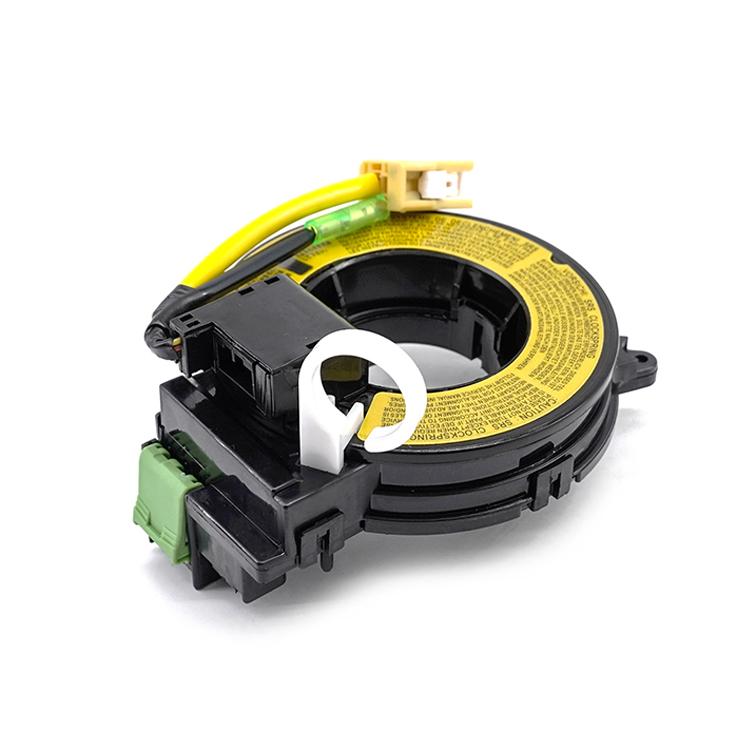 Clock spring coil with yellow label ring, green connector, and black plastic housing