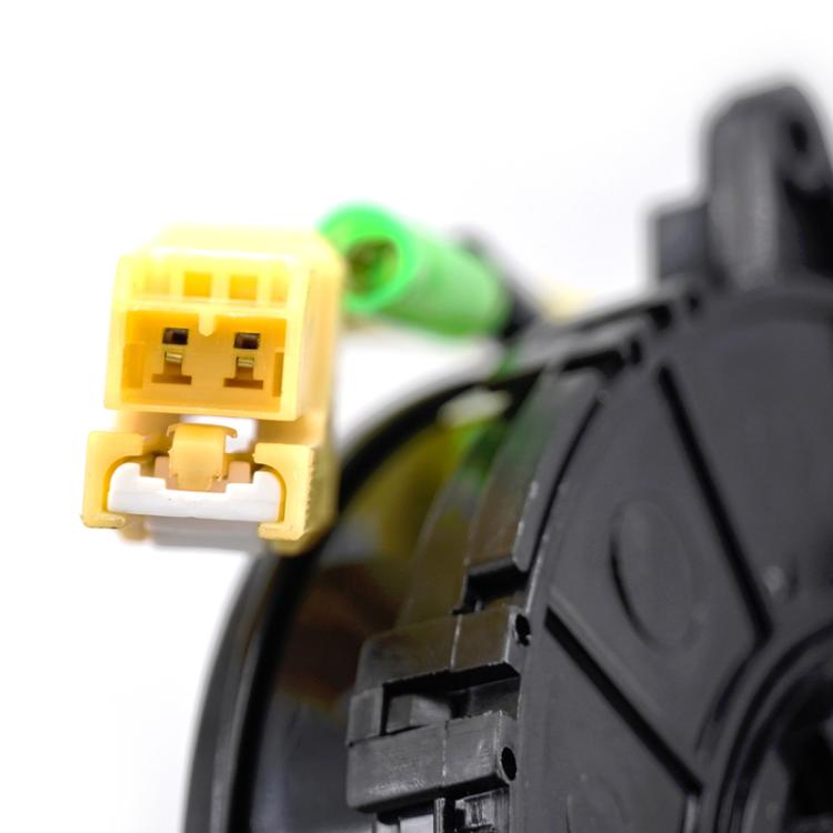 Close-up of clock spring coil with yellow plug connector and black cable housing