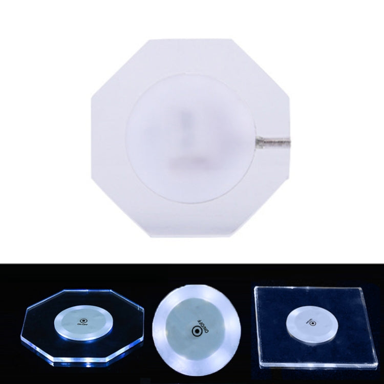Octagonal transparent LED acrylic coaster with white light, on/off button and slim crystal base.