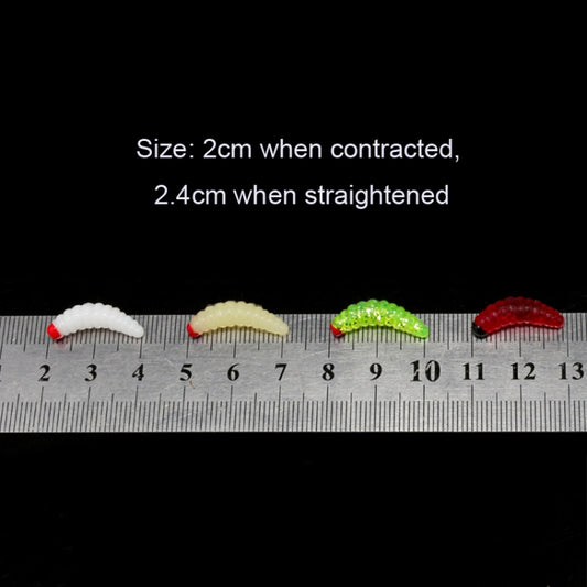 Small plastic headed worms with red beads beside ruler, size reference