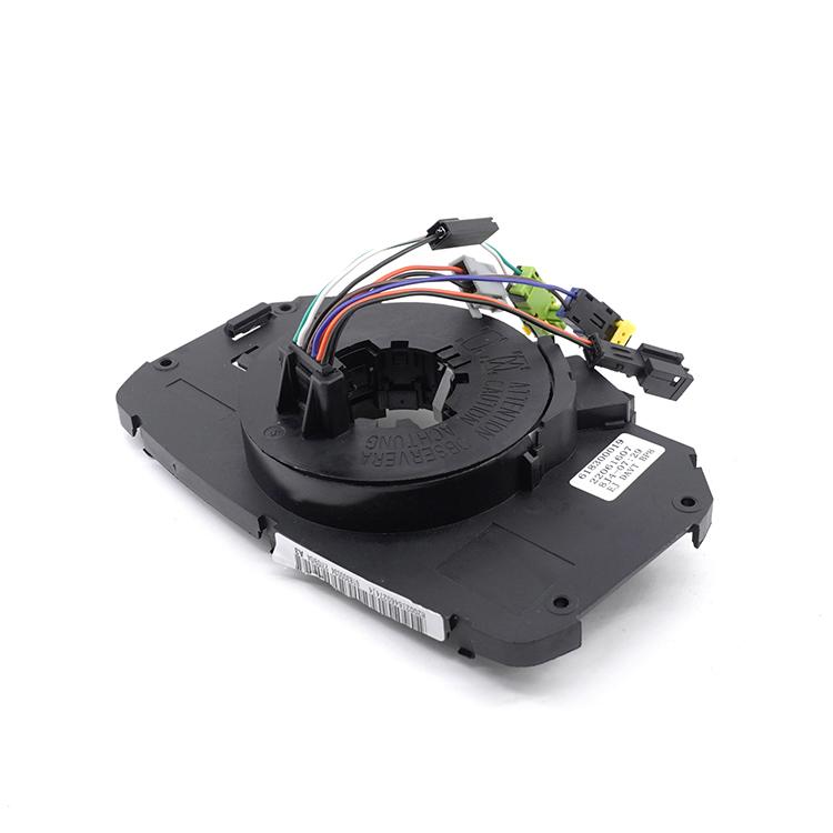 Steering wheel clock spring coil with black housing and attached multi-wire connectors
