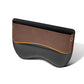 Brown and black car seat gap storage box with orange trim and stitched edges