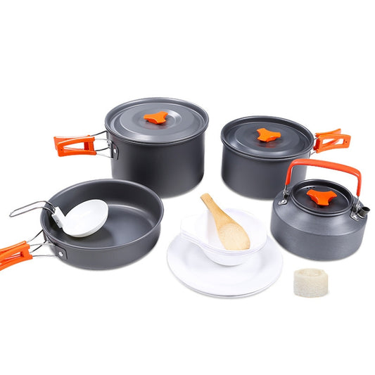Outdoor camping cookware set with gray pots, lids, orange handles, and plates