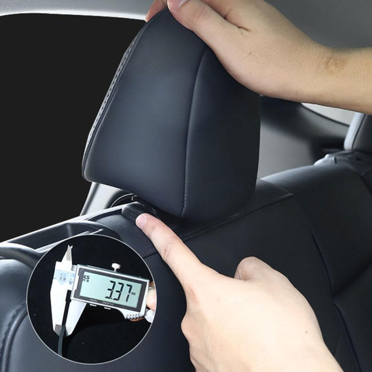 Hand installing a dark gray trunk hook on a car seat backrest