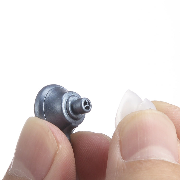 Dark blue earhook hearing aid close-up, showing the sound opening and fit piece.