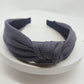 Pressed fabric headband, light gray with dark navy tips and knotted front wide band