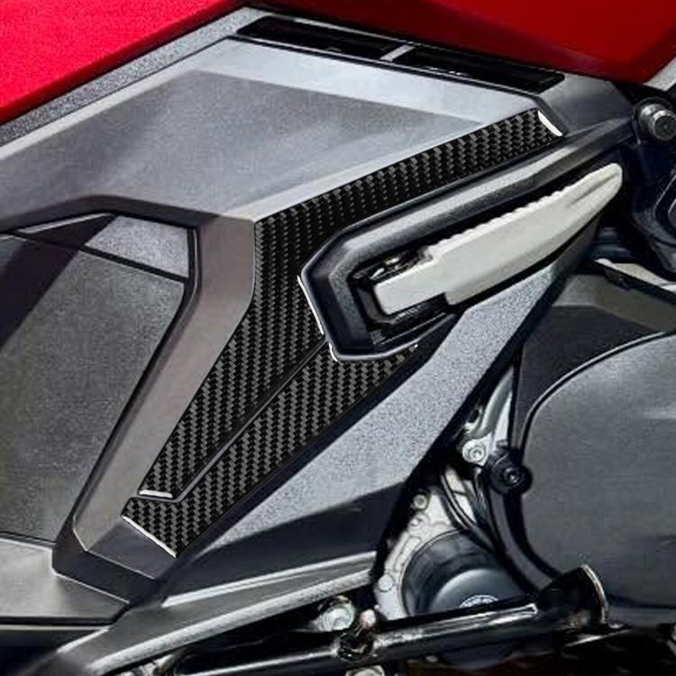 Rear footrest lower protector, black carbon-fiber style trim with raised channels