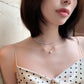 Pearl bead double-layer necklace with small teardrop pendant, worn at collarbone