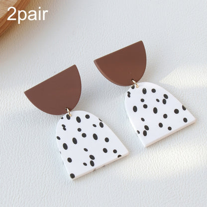 Acrylic clay dangle earrings, two pairs: white with black dots and brown caps