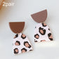 Acrylic clay dangle earrings, white with black-and-brown spots and brown caps