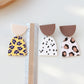 Acrylic clay dangle earrings with floral, polka-dot, and leopard-pattern teardrops