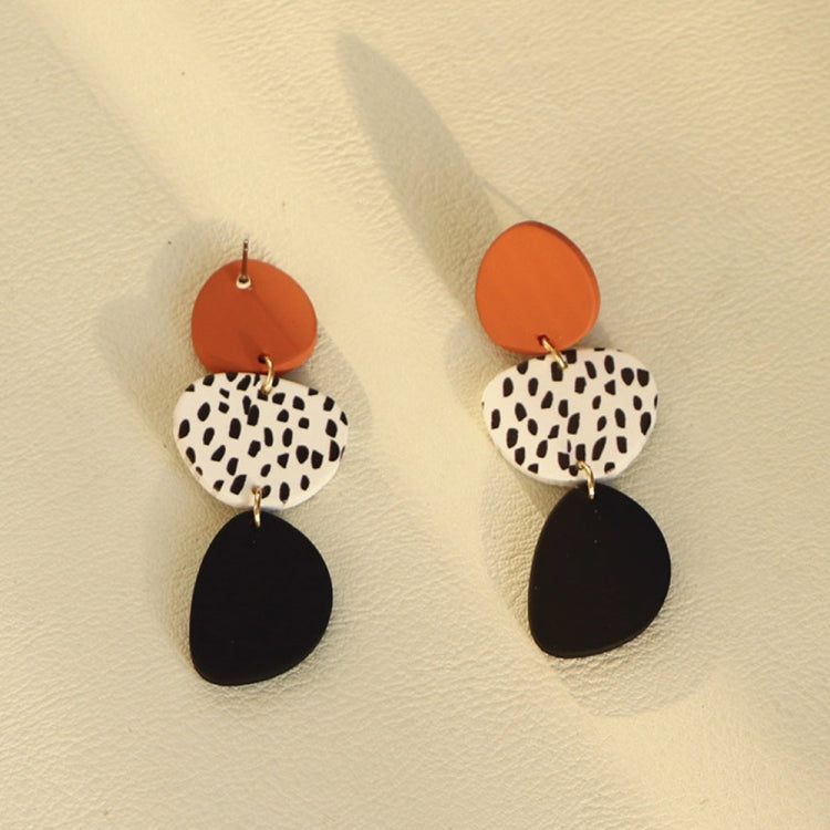 Dangle earrings with orange round tops, leopard print ovals, and black teardrop drops