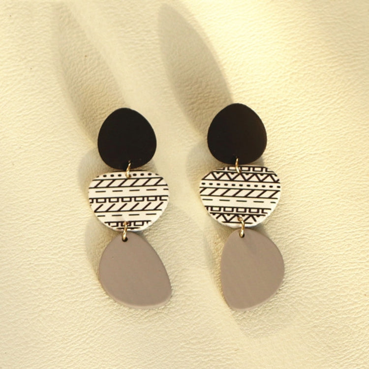Long acrylic drop earrings with black top, white geometric middle, gray oval dangles