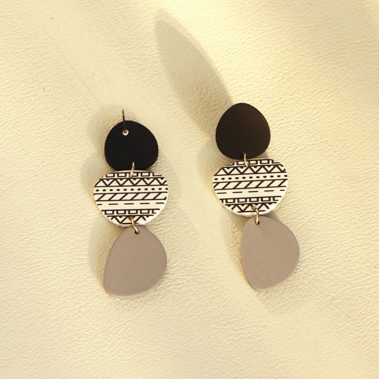 Long acrylic drop earrings with black top discs, white geometric halves, gray teardrops