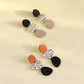 Acrylic long drop earrings set with orange and black spotted pairs, plus black/white geometric