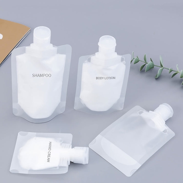 Set of white refillable squeeze pouches with flip-top caps for toiletries