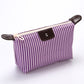 Purple striped folding cosmetic bag with zipper closure and dark leather-look patch
