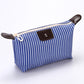 Blue striped folding cosmetic bag with zipper and dark leather-look front patch